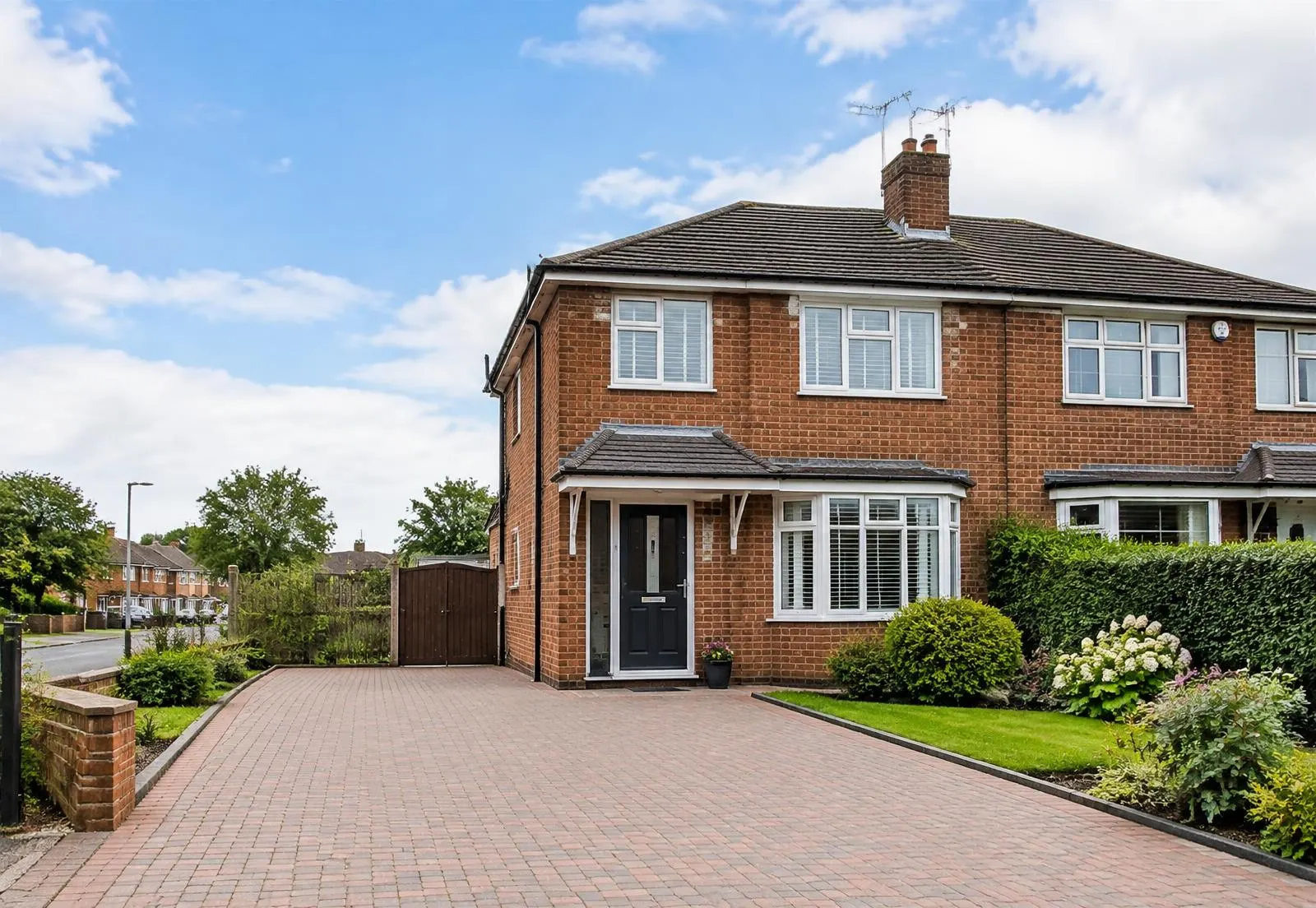 Clean semi-detached brick house with a freshly cleaned block-paved driveway